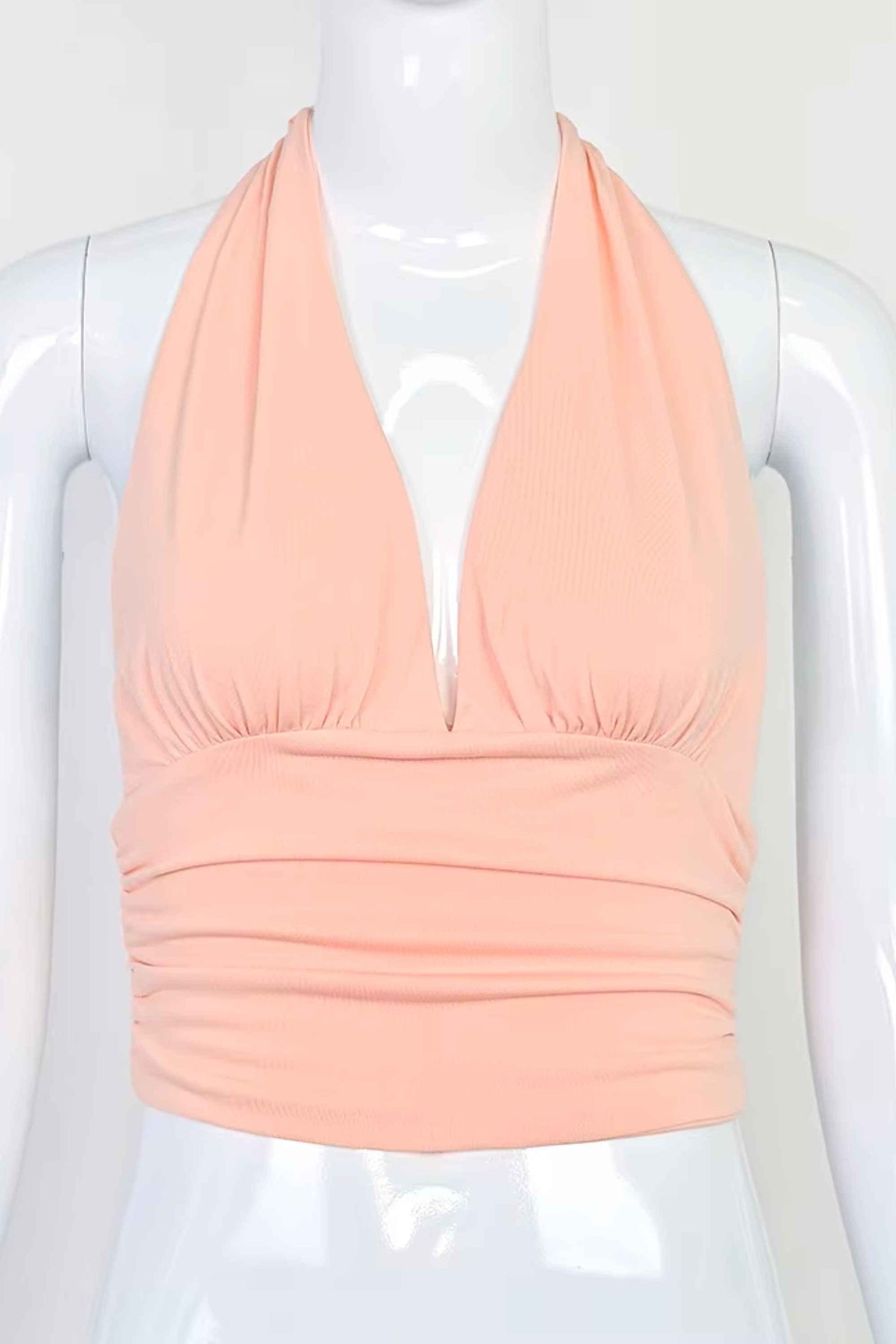 Woman wearing a figure flattering Aby Halter Top - Pink Peach Fuzz BODYCON COLLECTION Pty Ltd