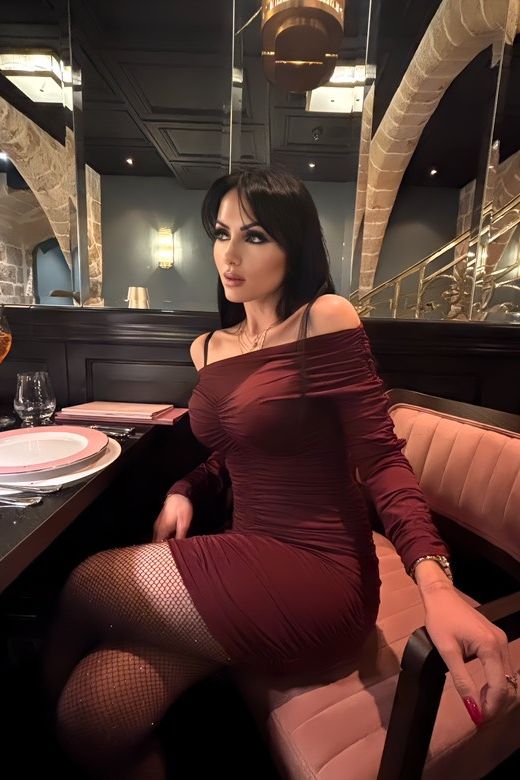 Woman wearing a figure flattering Alessandra Long Sleeve Wrap Bodycon Mini Dress - Classic Black BODYCON COLLECTION