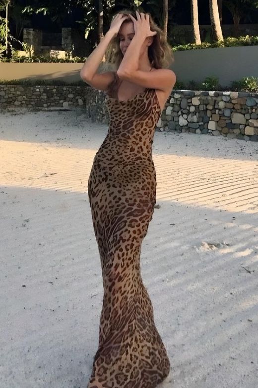 Woman wearing a figure flattering Athena Bodycon Maxi Dress - Leopard Print Yellow BODYCON COLLECTION