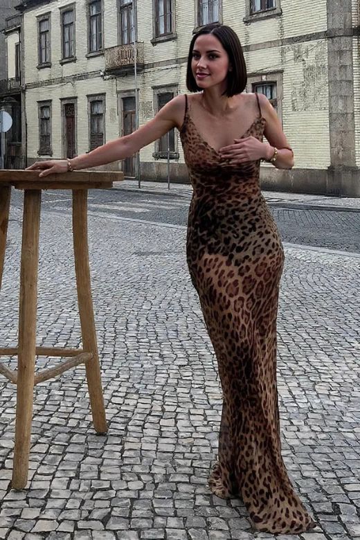 Woman wearing a figure flattering Athena Bodycon Maxi Dress - Leopard Print Yellow BODYCON COLLECTION
