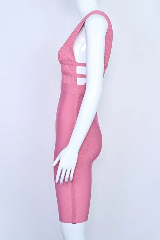 Woman wearing a figure flattering Bay Bandage Dress - Ballet Pink Bodycon Collection