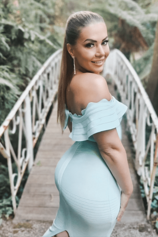 Woman wearing a figure flattering Billie Bandage Midi Dress - Violet Purple Bodycon Collection
