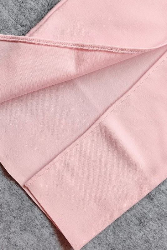 Woman wearing a figure flattering Blanche Bandage Maxi Dress - Dusty Pink BODYCON COLLECTION