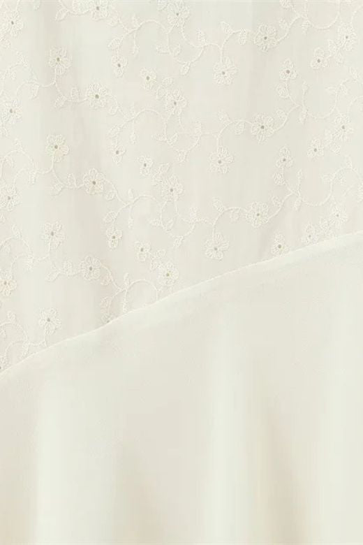 Woman wearing a figure flattering  Cali Wrap Top and Maxi Skirt Set - Ivory White BODYCON COLLECTION