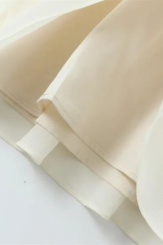 Woman wearing a figure flattering  Cali Wrap Top and Maxi Skirt Set - Ivory White BODYCON COLLECTION