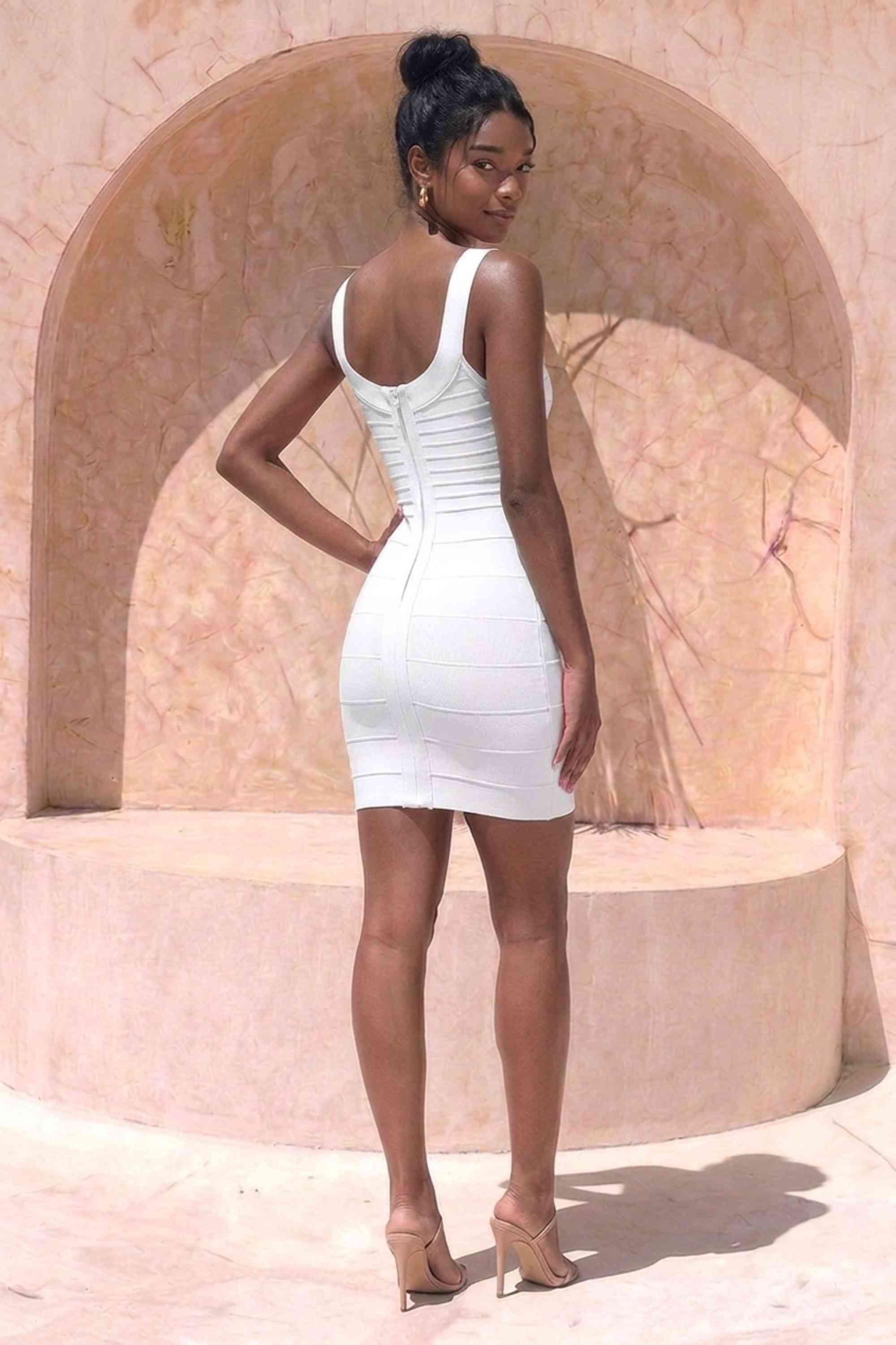 Woman wearing a figure flattering Cindy Bandage Mini Dress - White Pearl BODYCON COLLECTION Pty Ltd