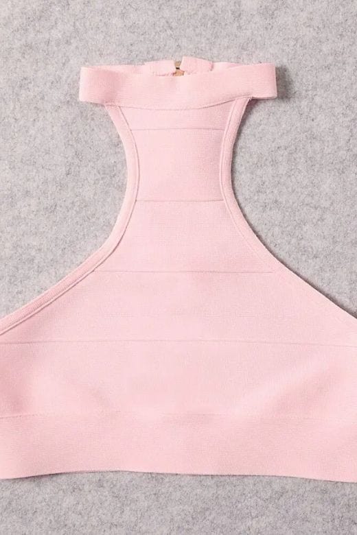 Woman wearing a figure flattering Elli Bandage Crop Top - Dusty Pink BODYCON COLLECTION