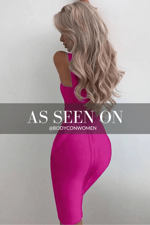 Woman wearing a figure flattering Freya Bandage Midi Dress - Magenta Pink BODYCON COLLECTION