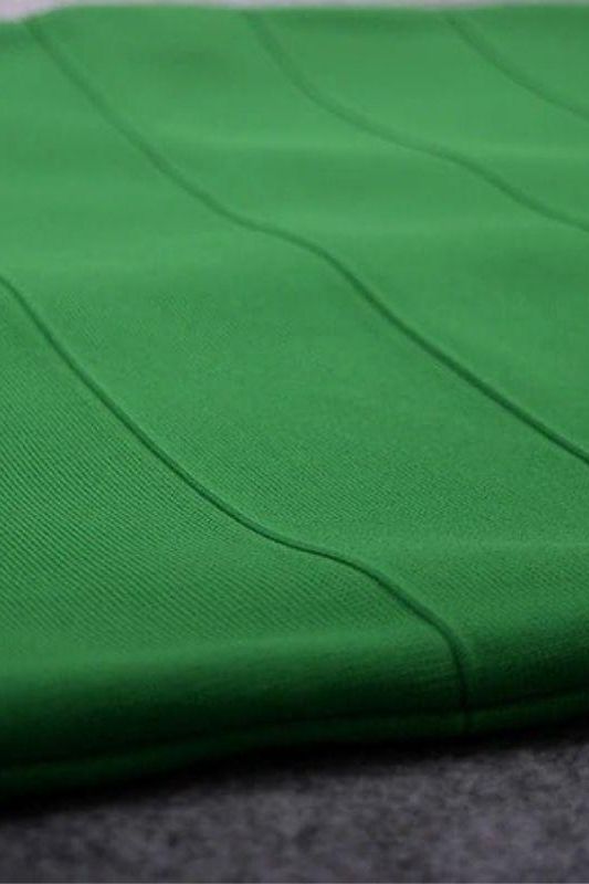 Woman wearing a figure flattering Heidi Bandage Midi Dress - Emerald Green Bodycon Collection