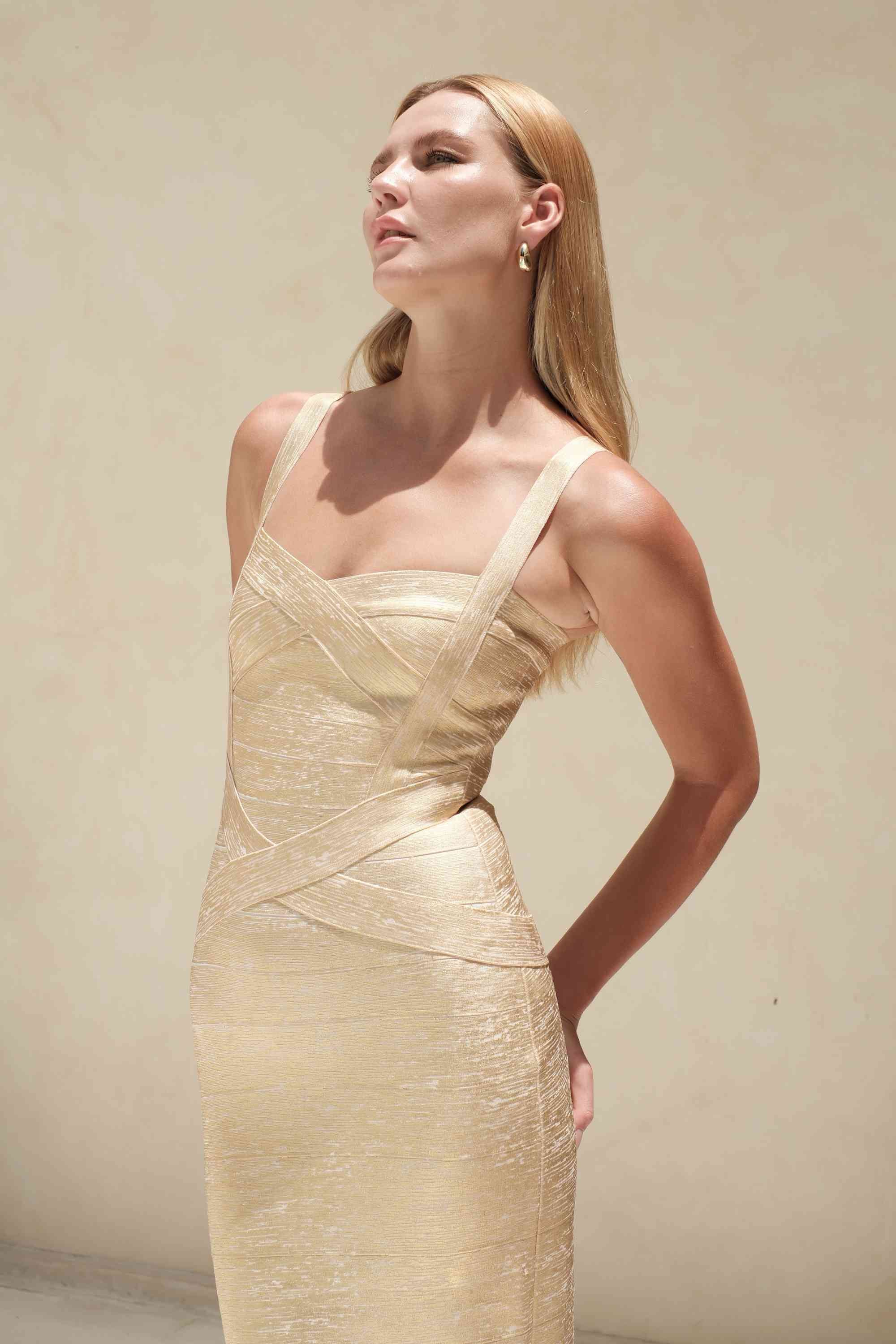Woman wearing a figure flattering Heidi Bandage Midi Dress - Gold BODYCON COLLECTION