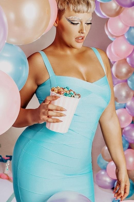 Woman wearing a figure flattering Heidi Bandage Midi Dress - Mustard Yellow Bodycon Collection