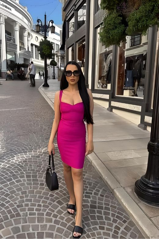 Woman wearing a figure flattering Heidi Bandage Mini Dress - Magenta Pink Bodycon Collection