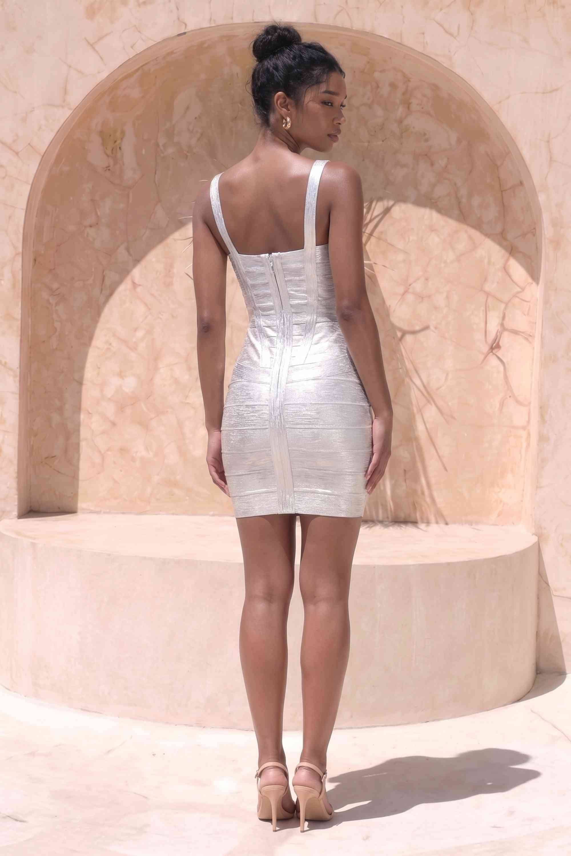 Woman wearing a figure flattering Heidi Bandage Mini Dress - Silver Bodycon Collection