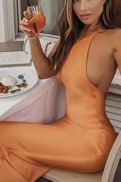 Woman wearing a figure flattering Joi Bodycon Midi Dress - Apricot Orange Bodycon Collection