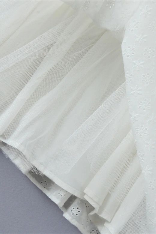 Woman wearing a figure flattering Mari Bodycon Mini Dress - Pearl White BODYCON COLLECTION