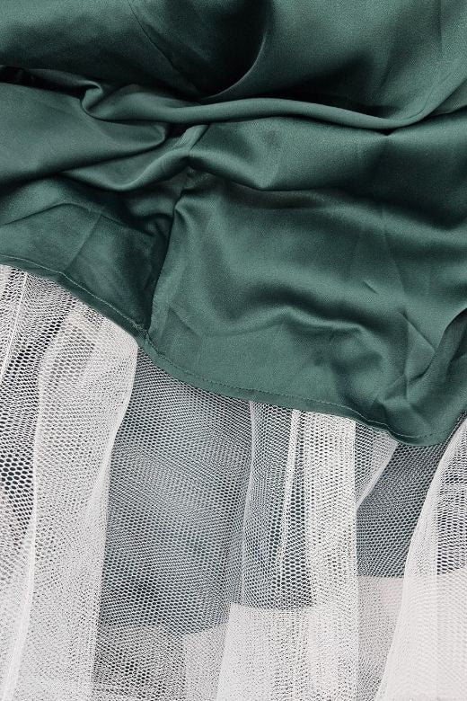 Woman wearing a figure flattering Mavis Midi Dress - Emerald Green BODYCON COLLECTION