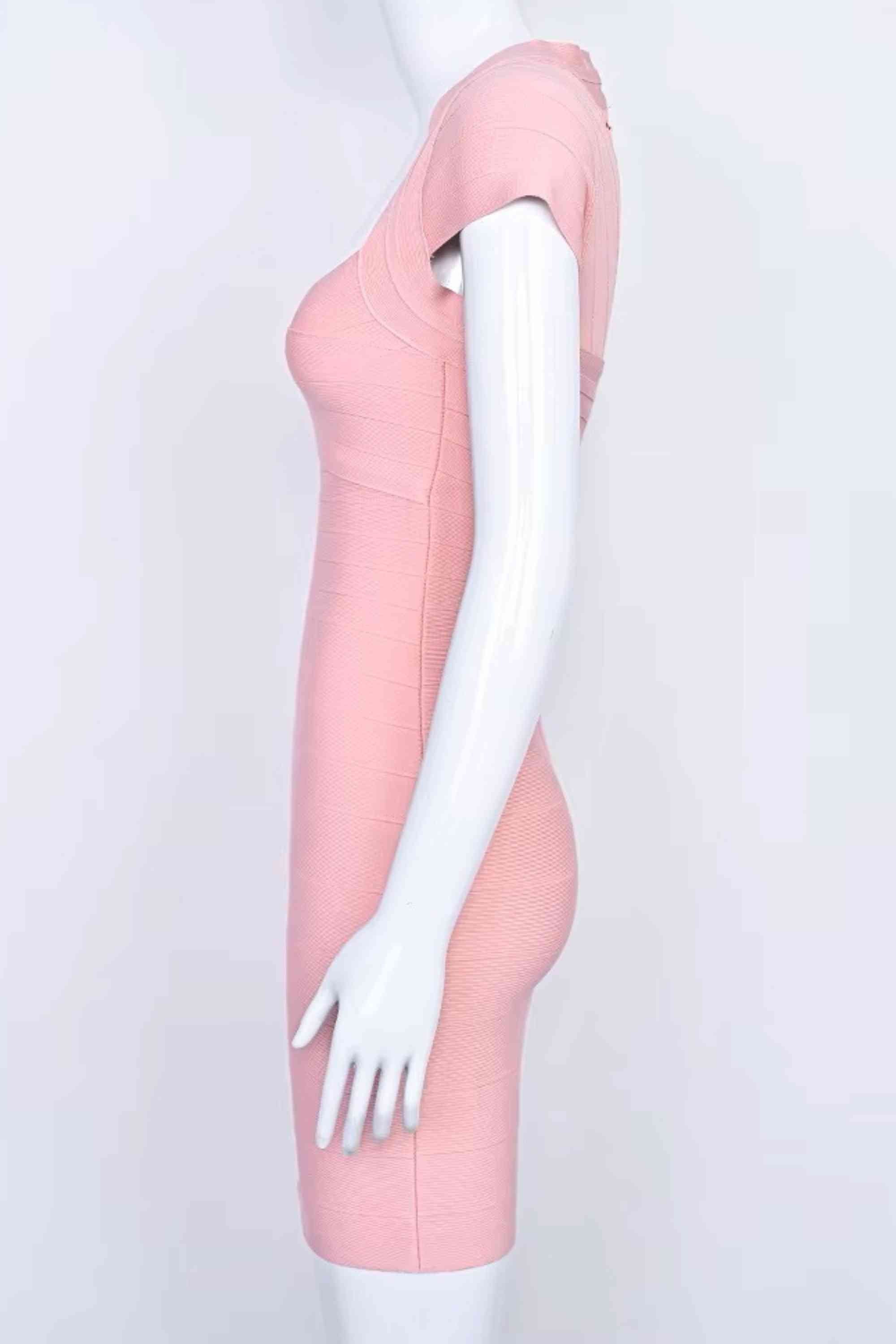 Woman wearing a figure flattering Miranda Bandage Mini Dress - Ballet Pink Bodycon Collection