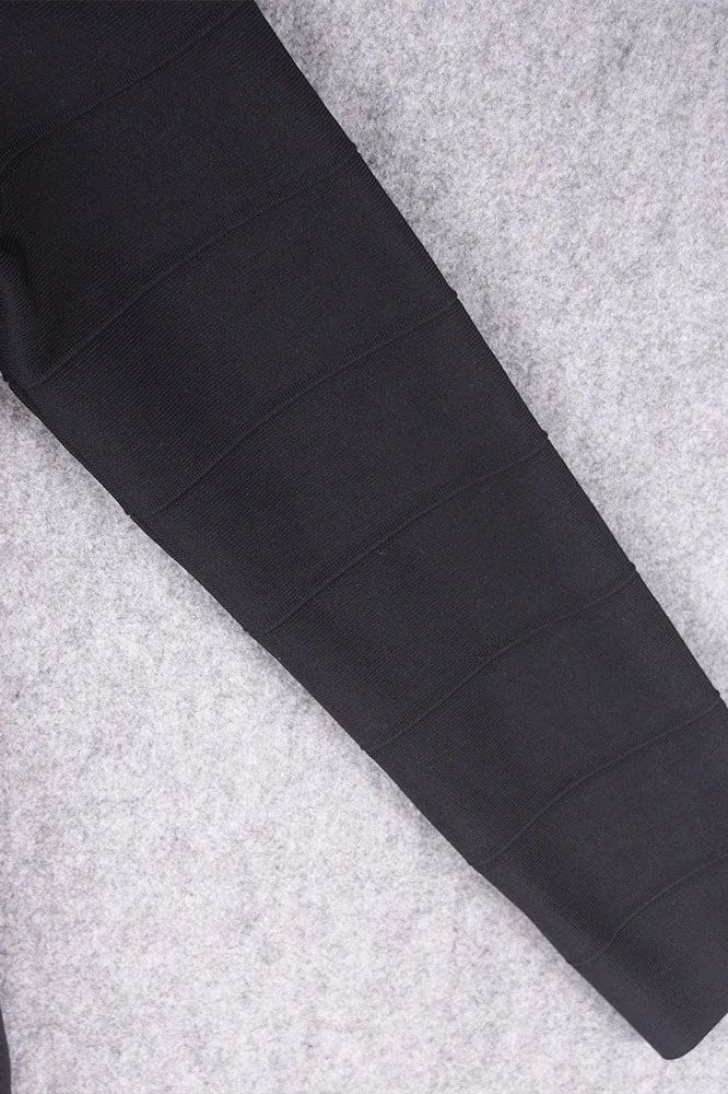 Woman wearing a figure flattering Pamela Long Sleeve Bandage Mini Dress - Classic Black BODYCON COLLECTION