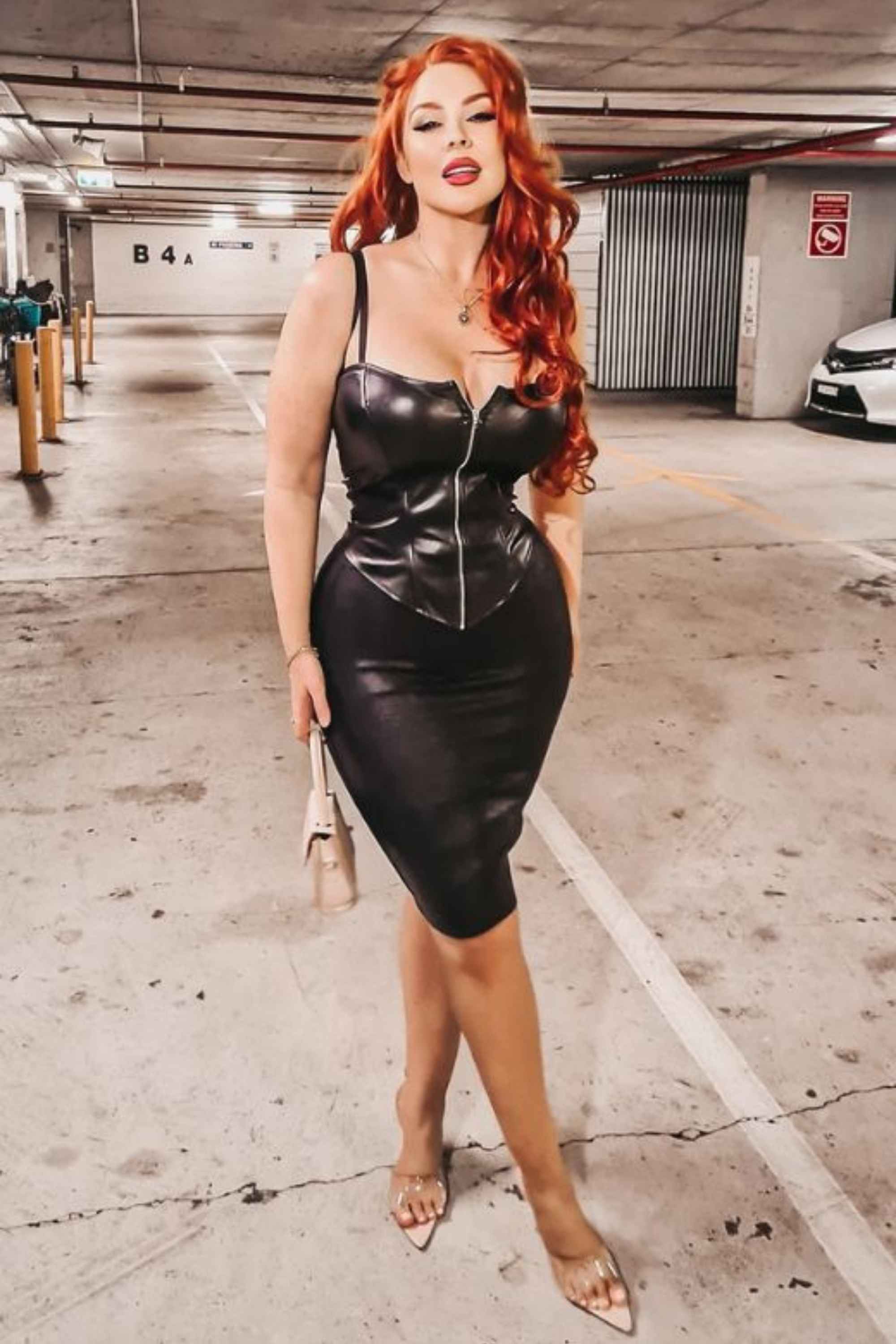 Woman wearing a figure flattering Pencil High Waist Leather Metallic Midi Skirt - Classic Black BODYCON COLLECTION