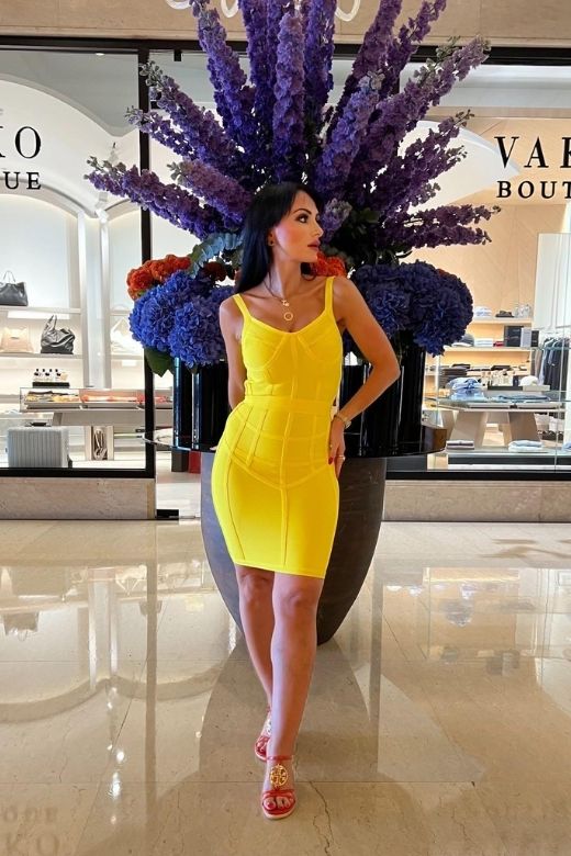 Woman wearing a figure flattering Pip Bandage Mini Dress - Sun Yellow BODYCON COLLECTION