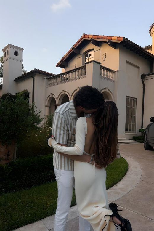 Woman wearing a figure flattering Regina Long Sleeve Bodycon Maxi Dress - Ivory White BODYCON COLLECTION