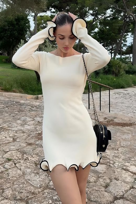 Woman wearing a figure flattering Regina Long Sleeve Bodycon Mini Dress - Classic Black BODYCON COLLECTION