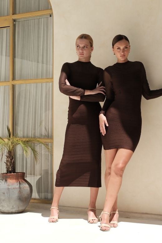 Woman wearing a figure flattering Robin Long Sleeve Bandage Maxi Dress - White Pearl BODYCON COLLECTION Pty Ltd