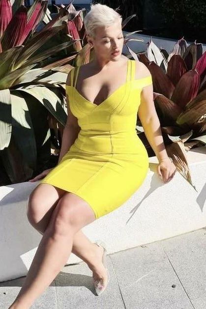 Woman wearing a figure flattering Sia Bandage Dress - Classic Black Bodycon Collection