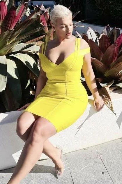 Woman wearing a figure flattering Sia Bandage Dress - Sun Yellow Bodycon Collection