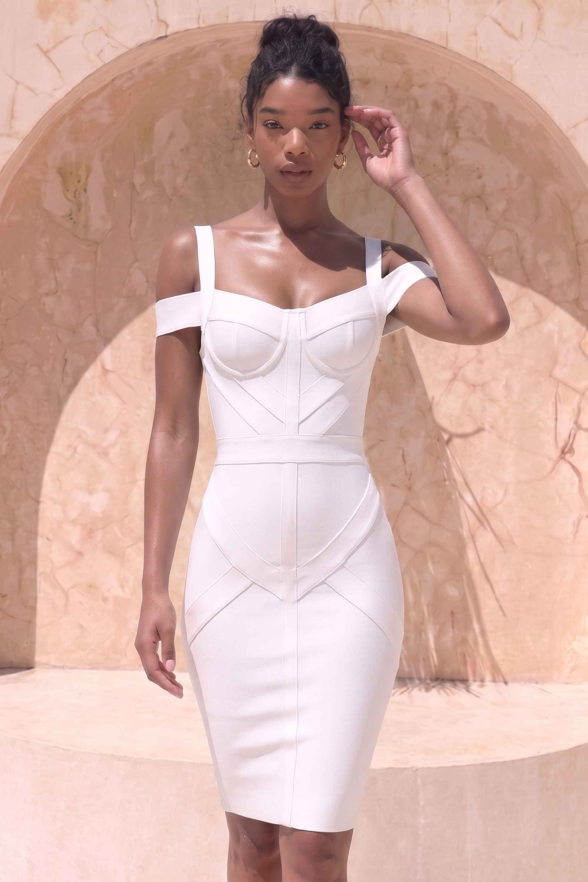 Woman wearing a figure flattering Sophia Bandage Dress - White Pearl Bodycon Collection