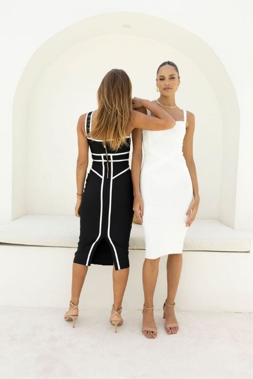 Woman wearing a figure flattering Suki Bandage Midi Dress - Classic Black BODYCON COLLECTION