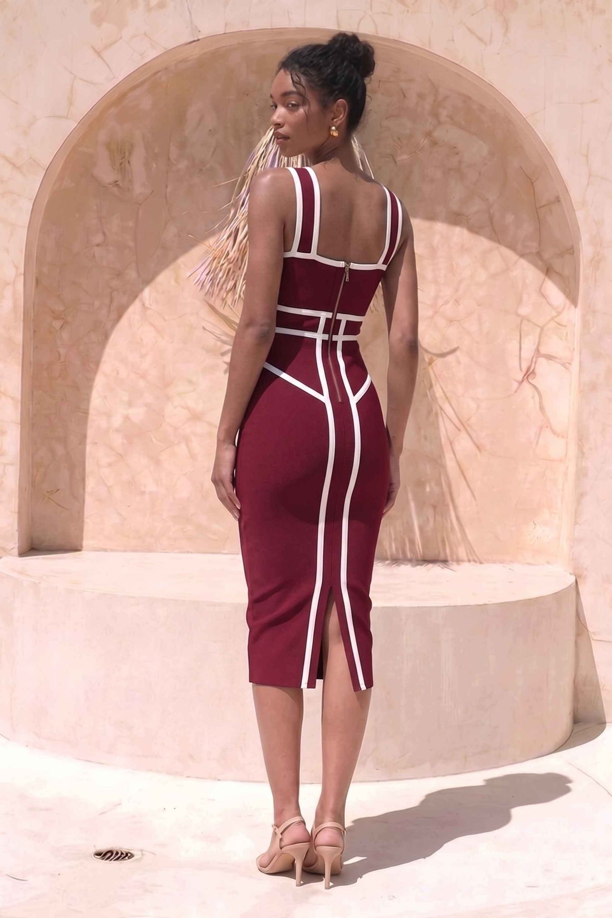 Woman wearing a figure flattering Suki Bandage Midi Dress - Red Wine BODYCON COLLECTION