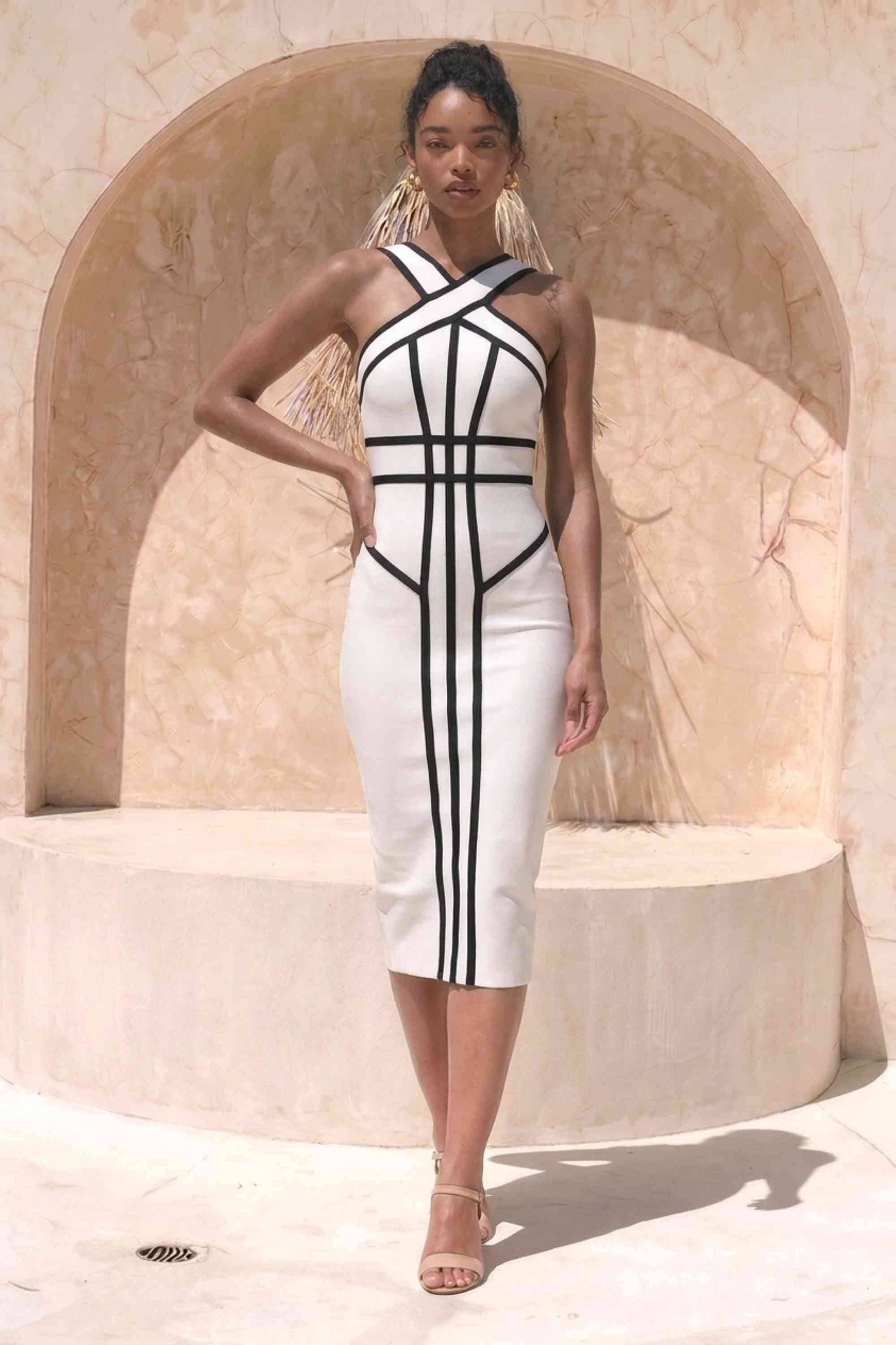 Woman wearing a figure flattering Suki Bandage Midi Dress - White Pearl BODYCON COLLECTION