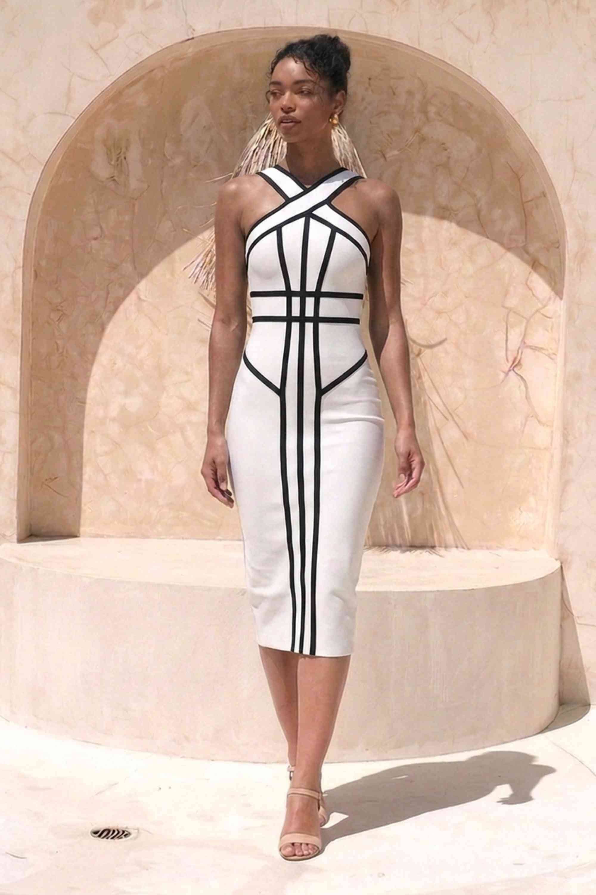 Woman wearing a figure flattering Suki Bandage Midi Dress - White Pearl BODYCON COLLECTION