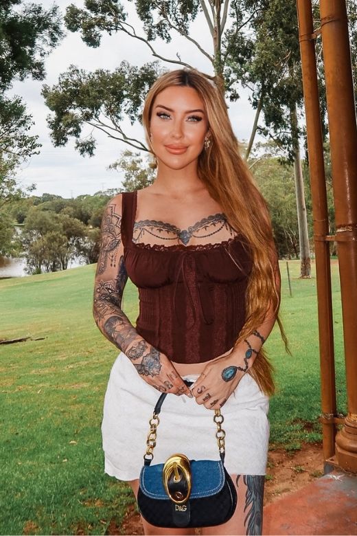 Woman wearing a figure flattering Valerie Corset Crop Top - Pearl White BODYCON COLLECTION