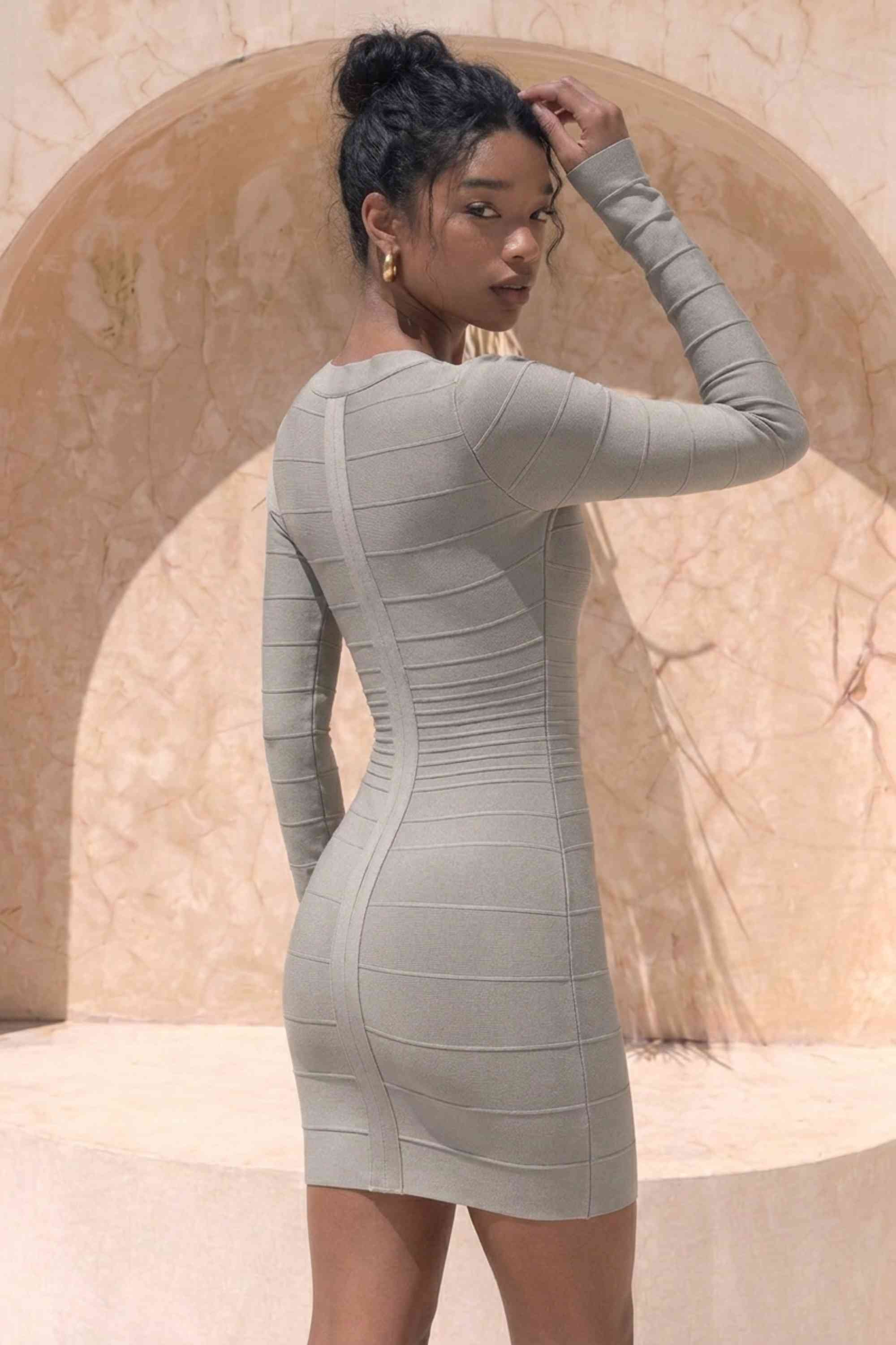 Woman wearing a figure flattering  Valentina Long Sleeve Bandage Mini Dress - Oyster Grey BODYCON COLLECTION Pty Ltd