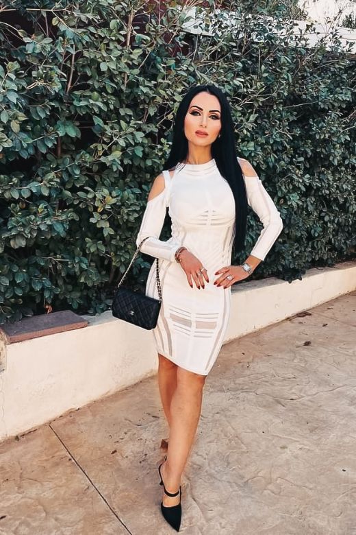 Woman wearing a figure flattering  Amelia Long Sleeve Bandage Dress - Pearl White BODYCON COLLECTION