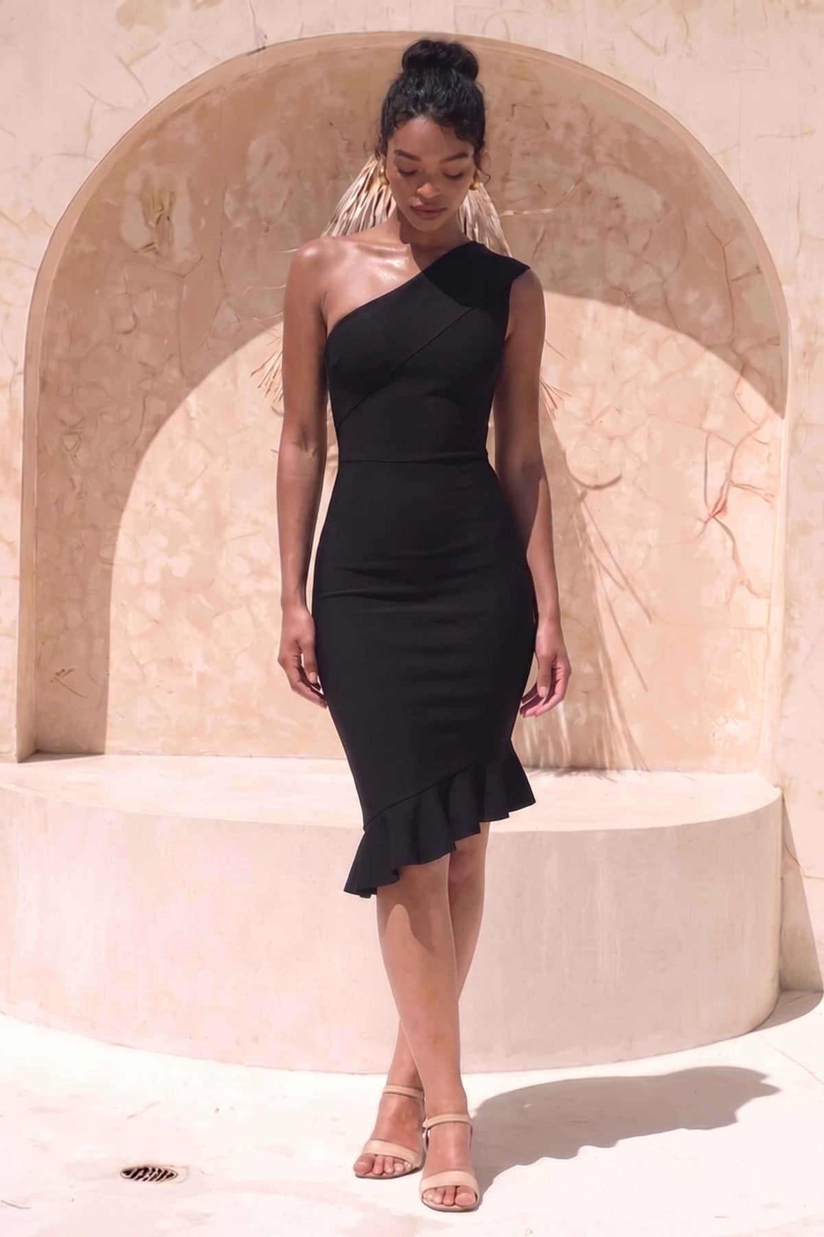 Woman wearing a figure flattering  Avery Bandage Dress - Classic Black BODYCON COLLECTION