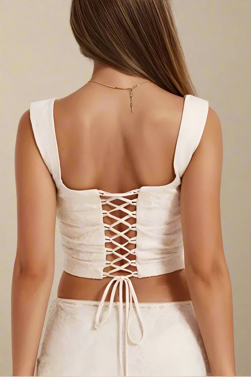 Woman wearing a figure flattering  Darling Corset Crop Top - Ivory BODYCON COLLECTION