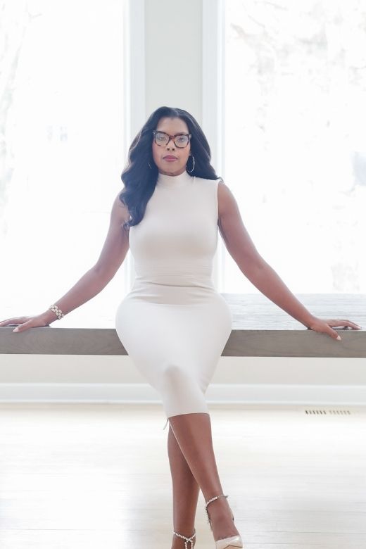 Woman wearing a figure flattering  Grace Bandage Midi Dress - Cream Bodycon Collection