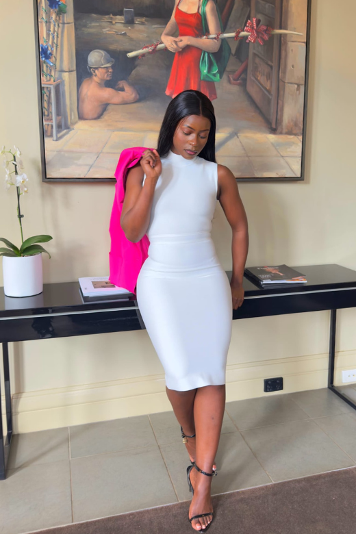 Woman wearing a figure flattering  Grace Bandage Midi Dress - White Pearl Bodycon Collection