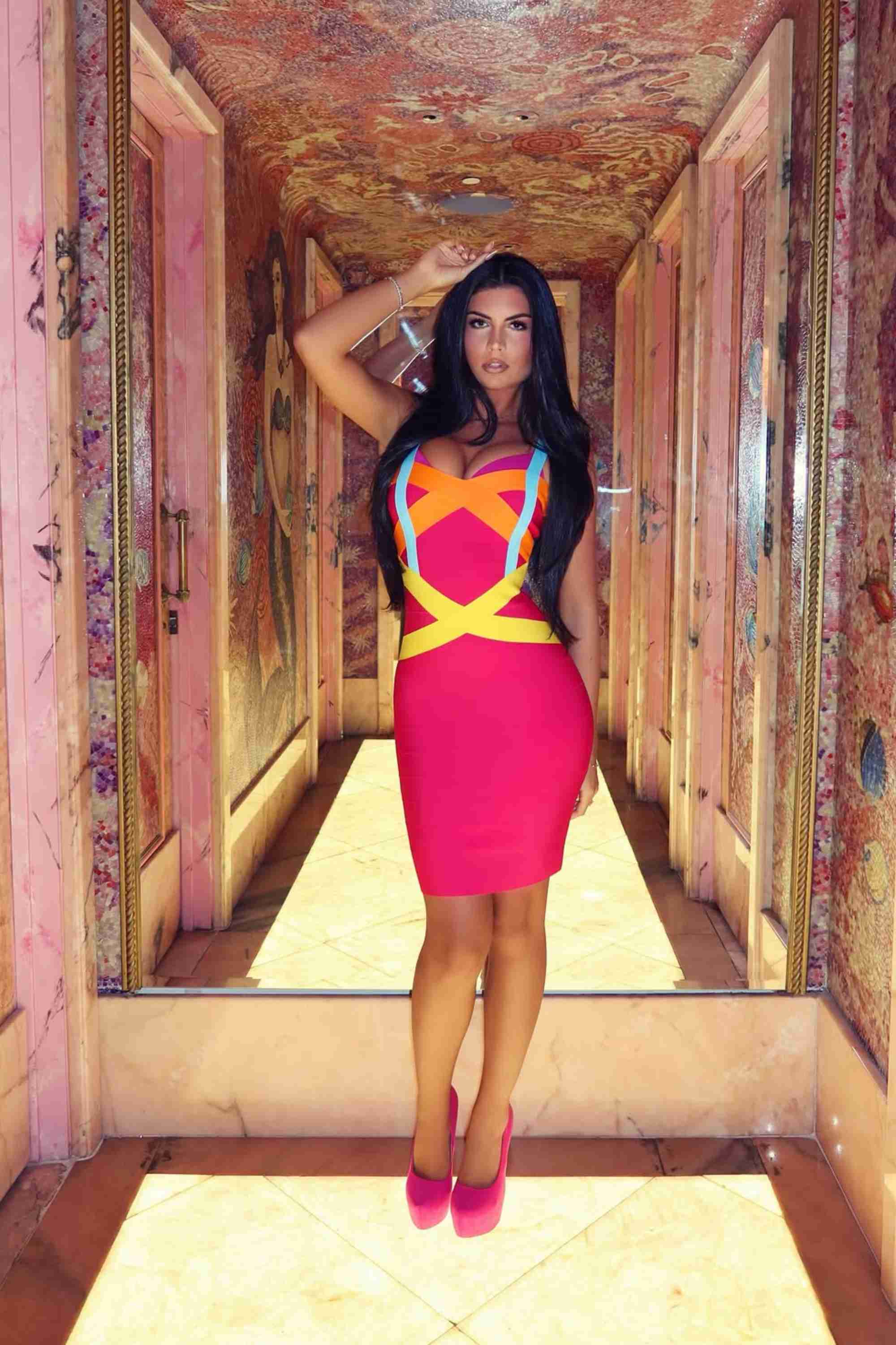 Woman wearing a figure flattering  Heidi Bandage Mini Dress - Hot Pink Bodycon Collection