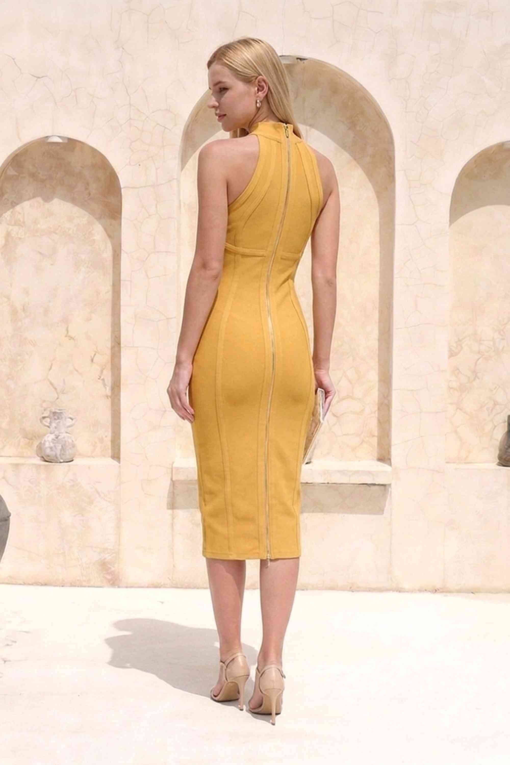 Woman wearing a figure flattering  Lea Bandage Midi Dress - Mustard Yellow Bodycon Collection