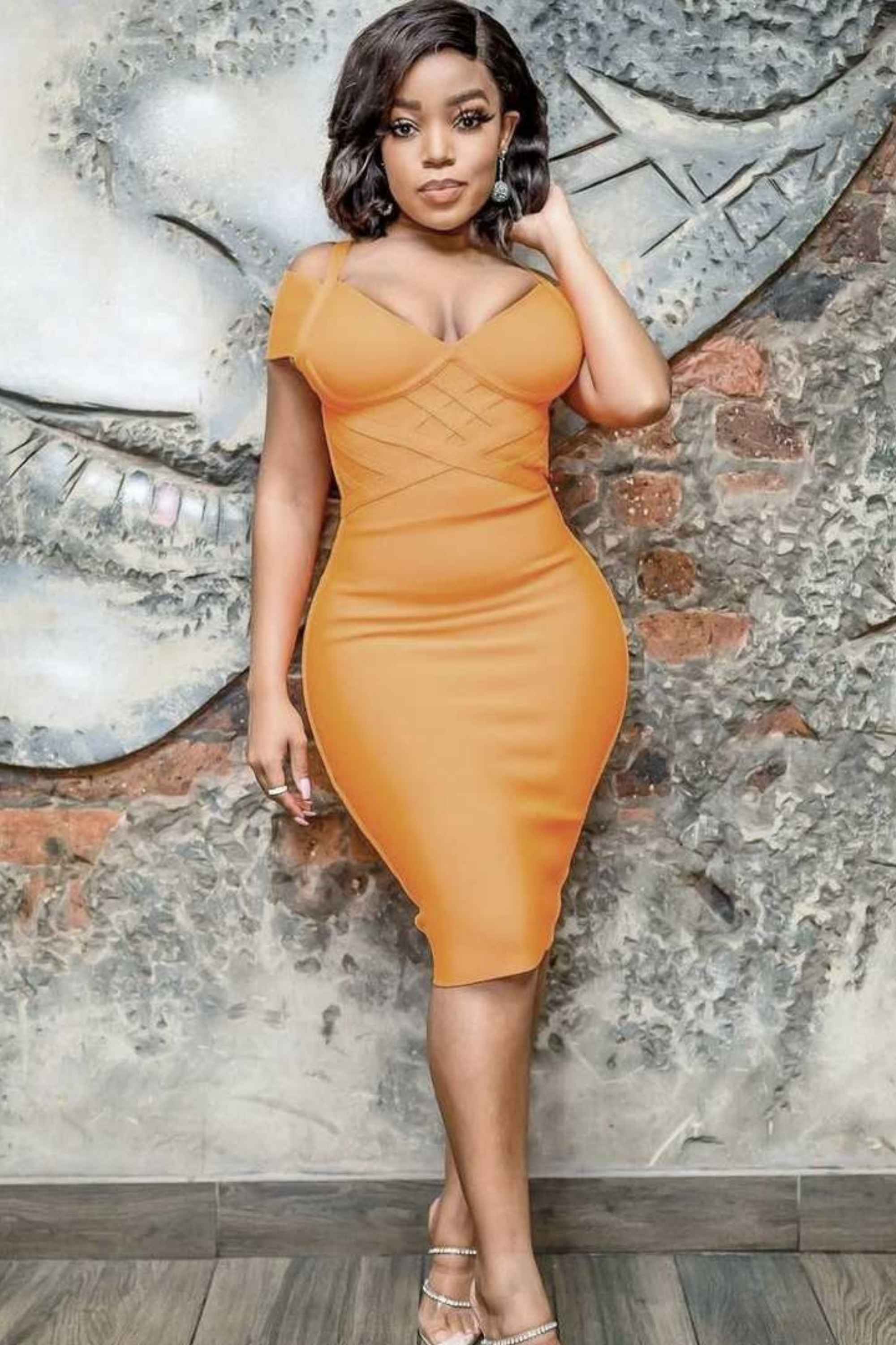 Woman wearing a figure flattering  Leo Bandage Dress - Apricot Orange Bodycon Collection
