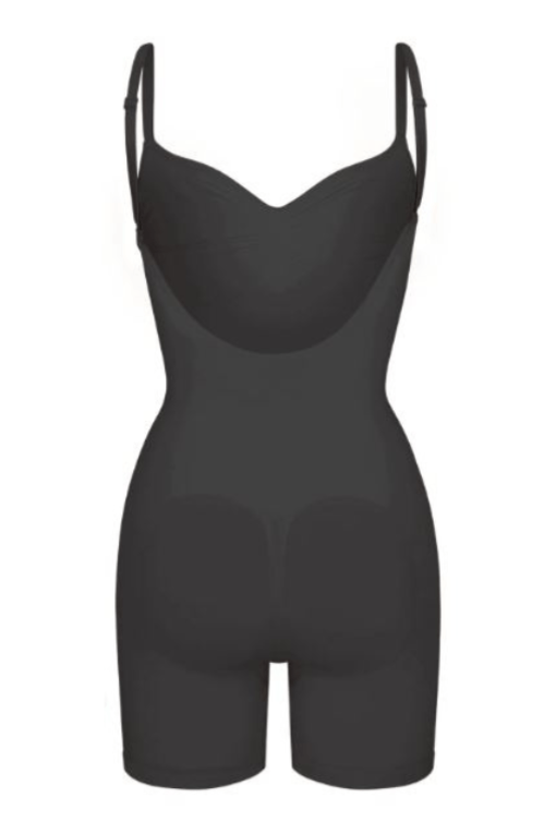 Woman wearing a figure flattering  Low Back One Piece Bodysuit Shapewear - Mid Thigh Bodycon Collection