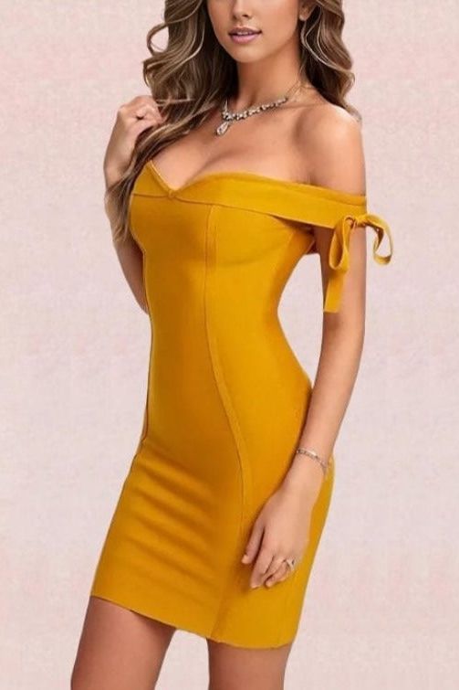 Woman wearing a figure flattering  Penelope Bandage Mini Dress - Mustard Yellow BODYCON COLLECTION