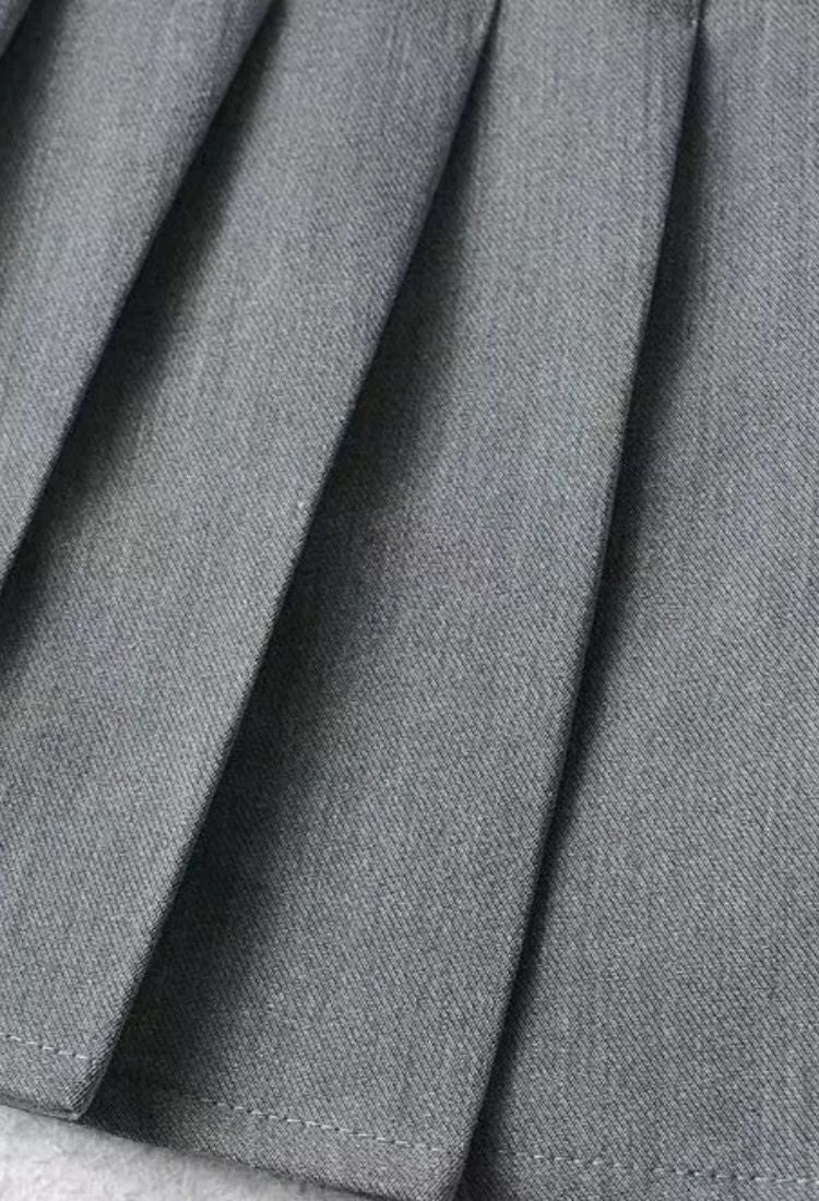 Woman wearing a figure flattering  Pleated Mini Skirt - Classic Black BODYCON COLLECTION Pty Ltd