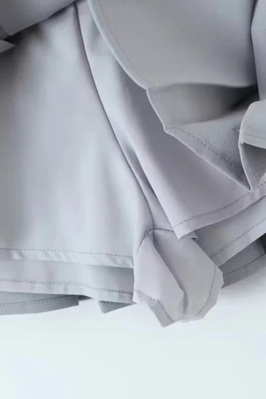 Woman wearing a figure flattering  Pleated Sports Mini Skirt - Cloud Grey BODYCON COLLECTION Pty Ltd