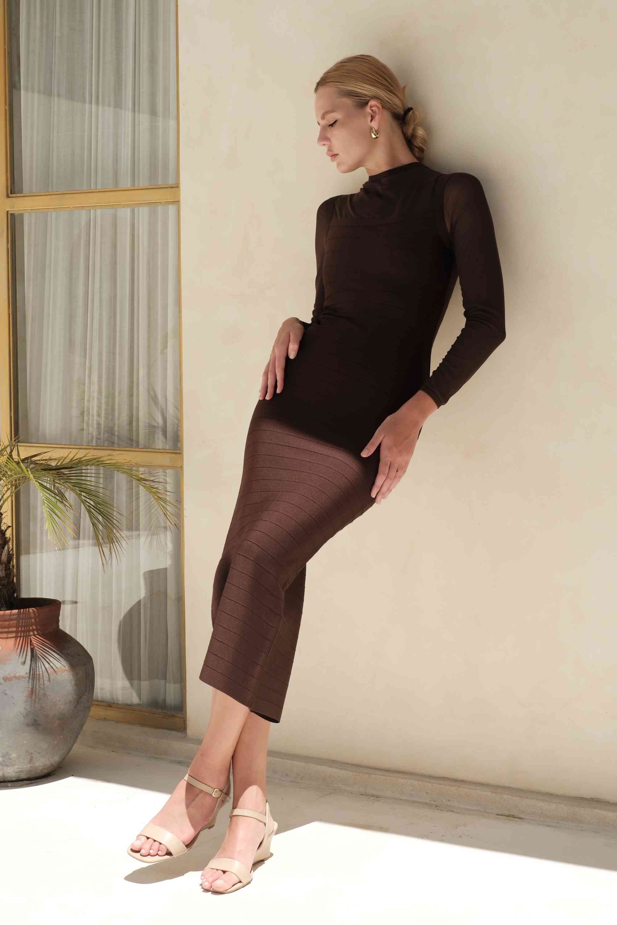 Woman wearing a figure flattering  Robin Long Sleeve Bandage Maxi Dress - White Pearl BODYCON COLLECTION Pty Ltd