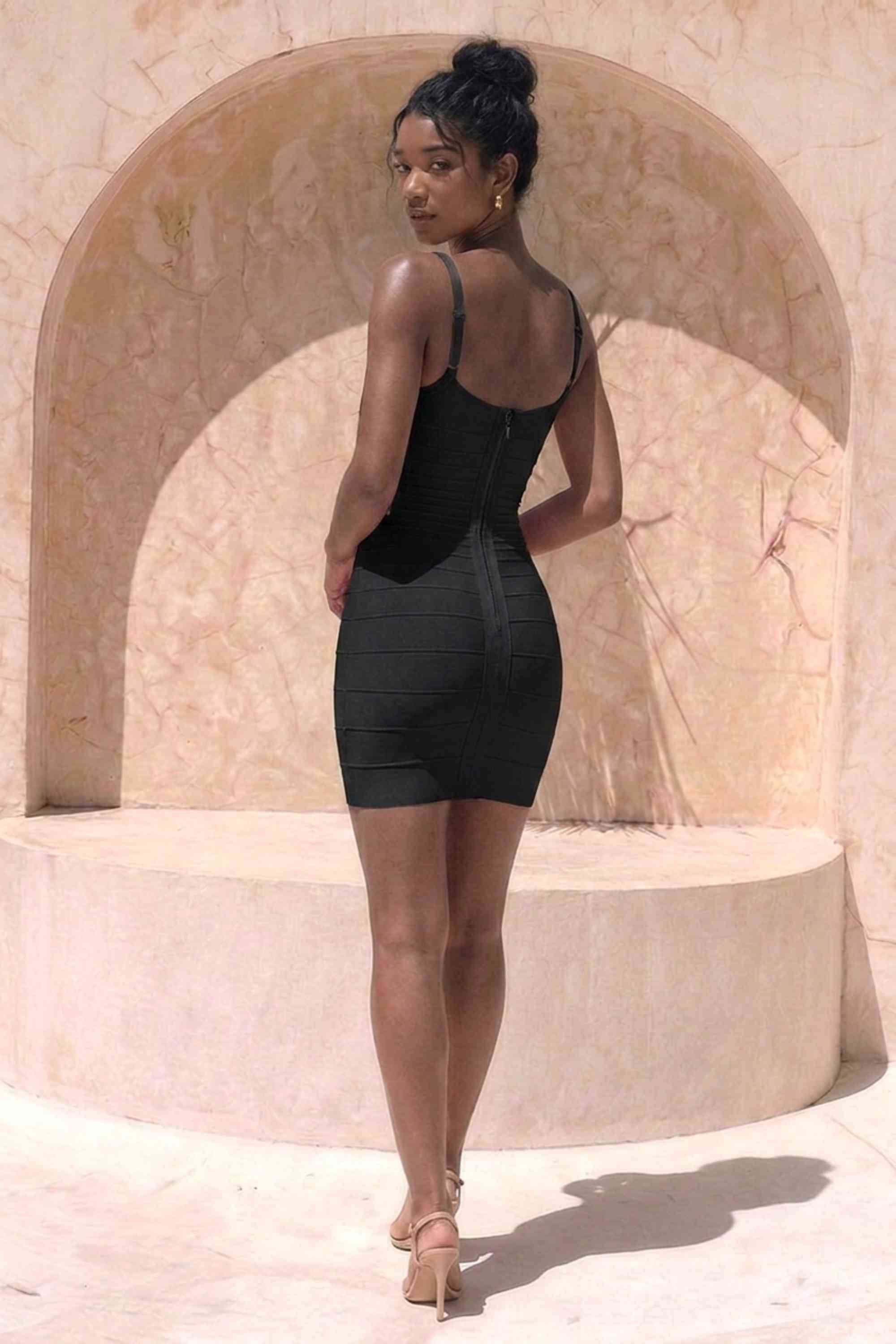 Woman wearing a figure flattering  Scarlett Bandage Mini Dress - Classic Black BODYCON COLLECTION Pty Ltd